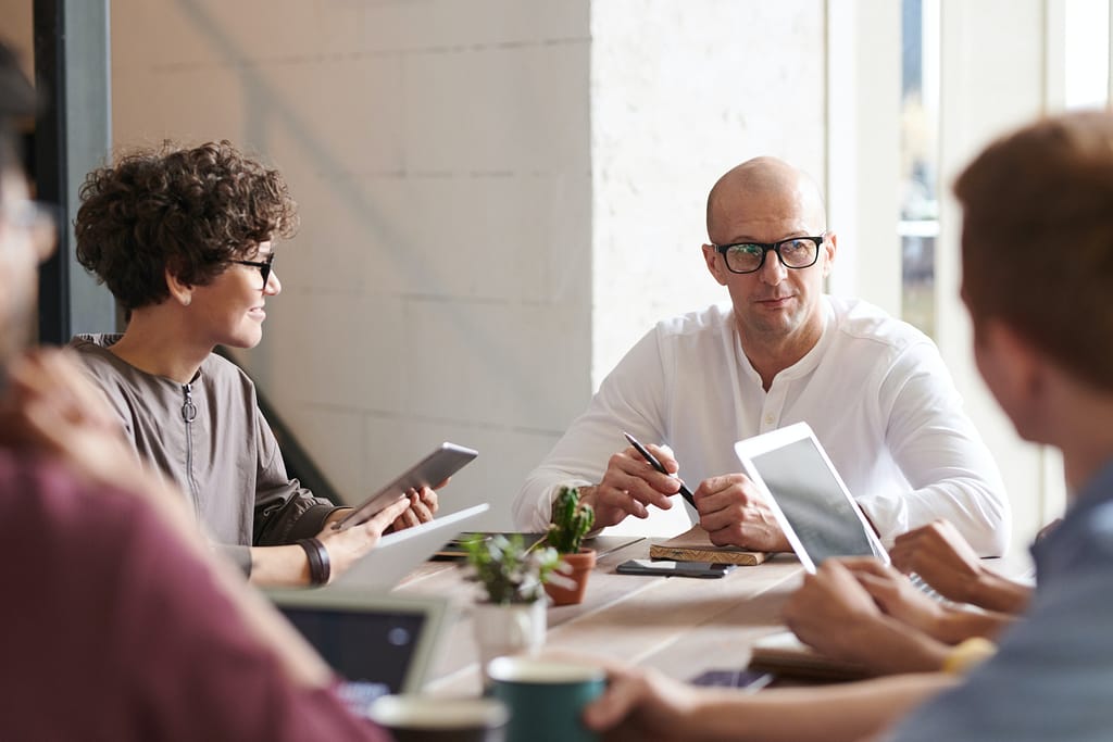 Employees practicing Effective Communication in a meeting room.